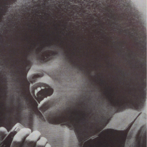 Photograph of Angela Davis speaking into a microphone.