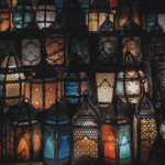 A collection of multicolored lanterns with detailed cutouts and colorful lights.