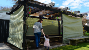 Jewish woman and child visiting their family Sukkah in the Jewish festival of Sukkot. A Sukkah is a temporary structure where meals are taken for the week.