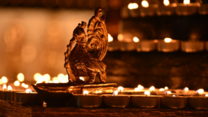 Gold dragon sculpture surrounded by shallow bowls with candles.