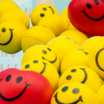 Yellow and red squish balls with smiley faces, 10/10, Express Yourself with Squish Balls.