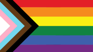 Pride month flag featuring triangle of white, pink, blue, brown, and black with rainbow stripes of red, orange, yellow, green, blue, and purple.
