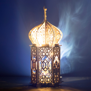 Wooden cutout of Ramadan lantern against a royal blue background.