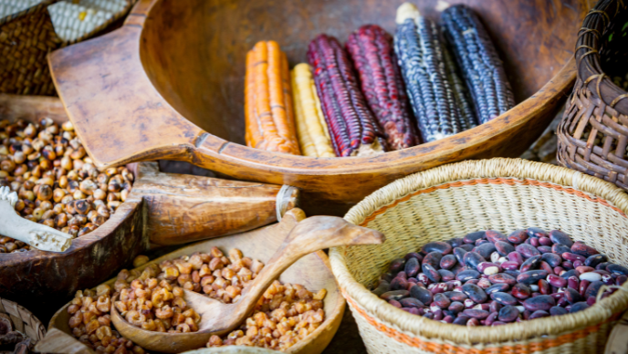 Colorful cobs of corn in a variety of baskets and bowls.