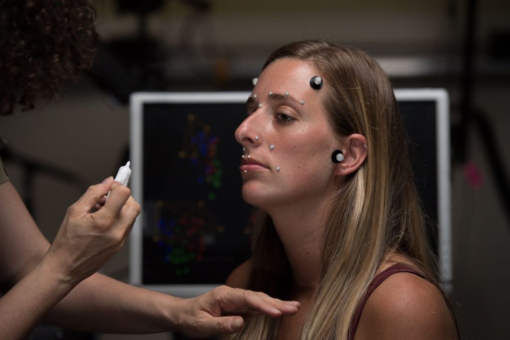 A Communication Disorders student participates in an experiment for speech movement. Research is an important component of the SLP program.