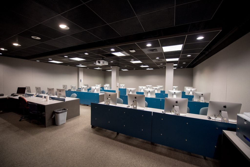 Empty computer lab in the Walker Building with rows of computer stations.