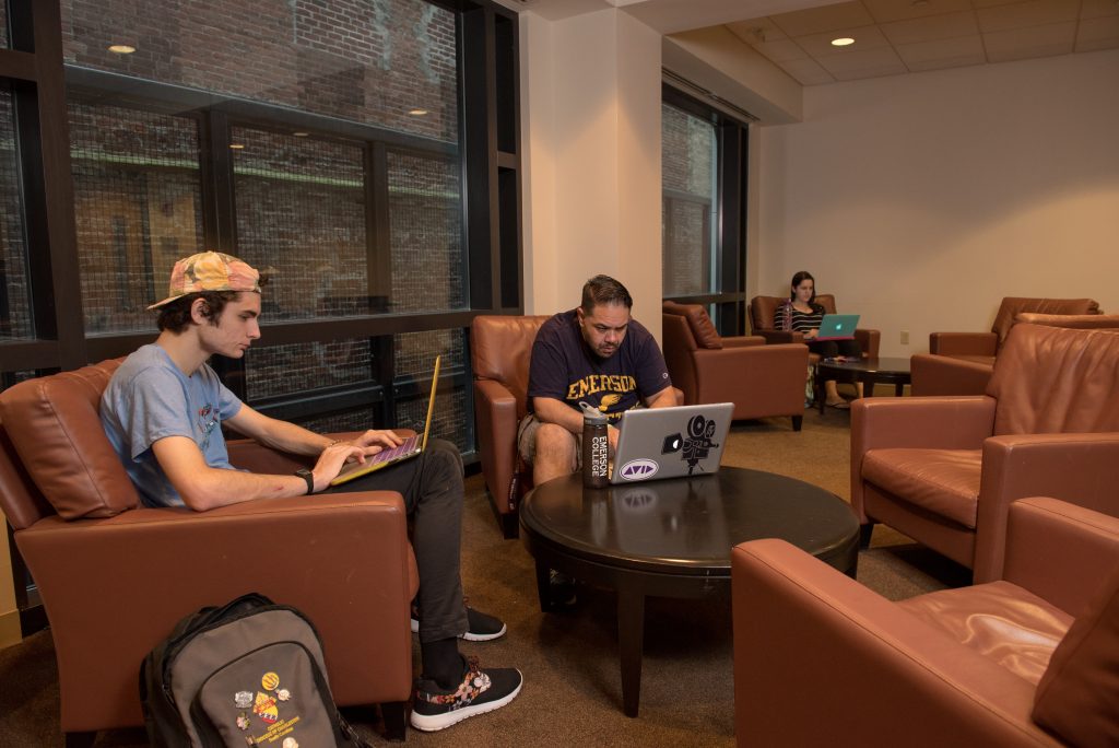 Two Emerson students using their laptops in the Quiet Study area in the Piano Row building.