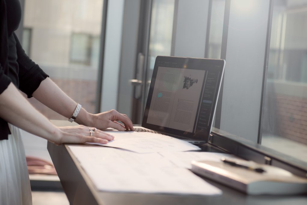 Graduate student working on a book manuscript on their laptop to prepare for a career in writing and publishing. 