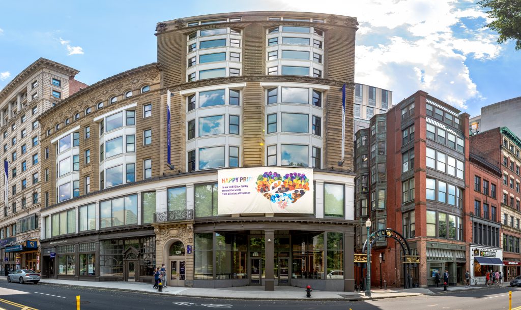 A panoramic view of an Emerson building downtown with a banner reading "Happy Pride" hanging.