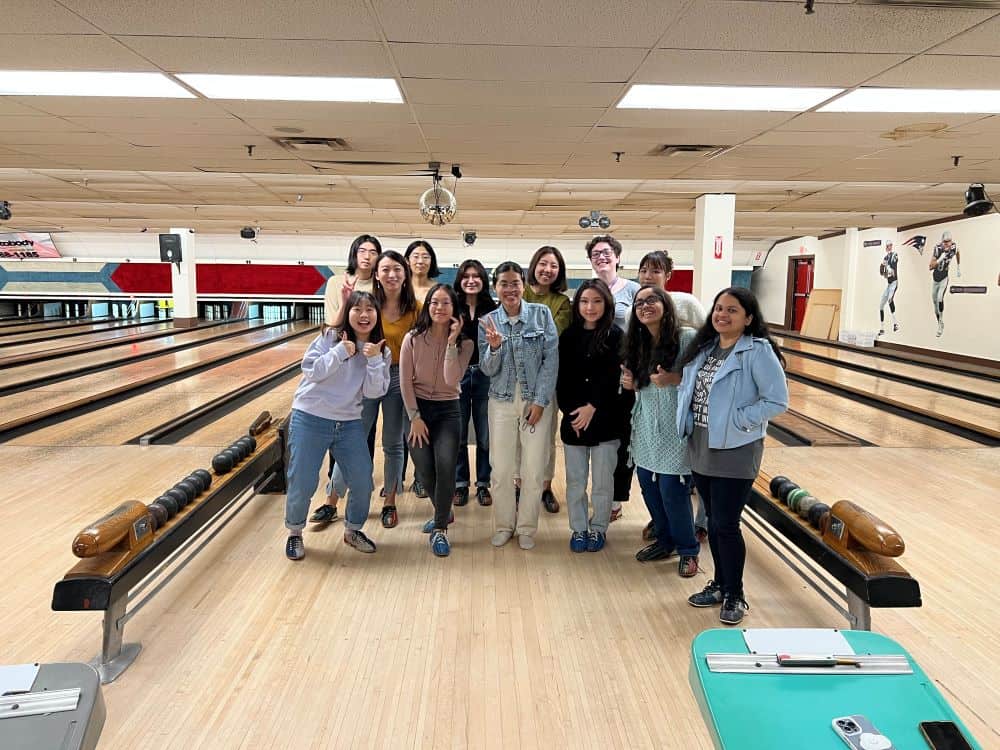 IGSO club members posing in front of a bowling lane