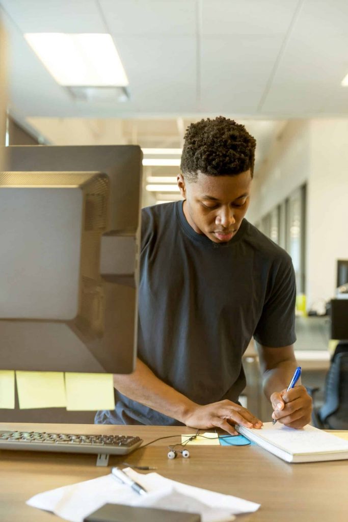 Graduate school applicant researches at a computer