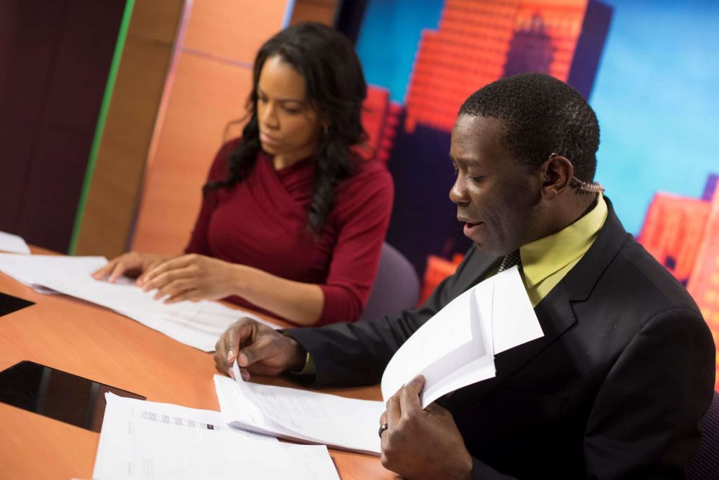 Two journalism students prepare for broadcasting