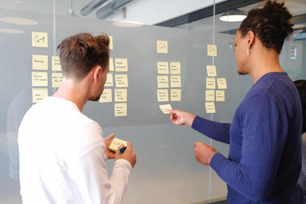 Two creative marketers brainstorming with sticky notes