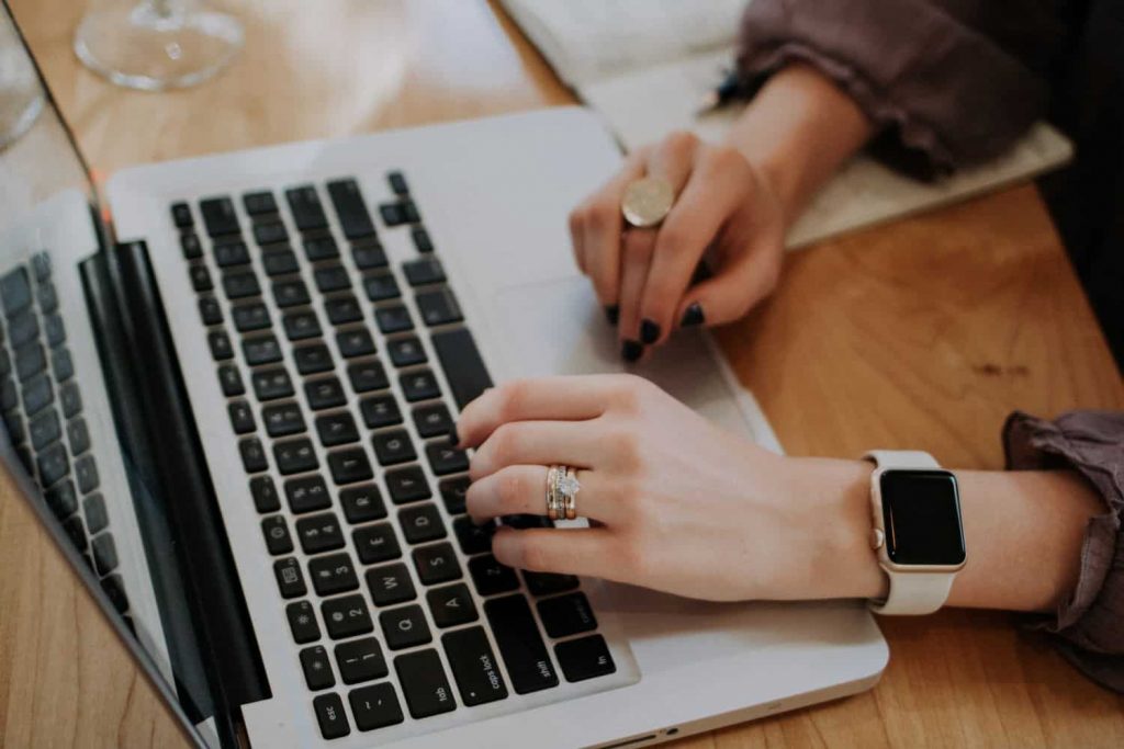 A student types their application essay for a scholarship