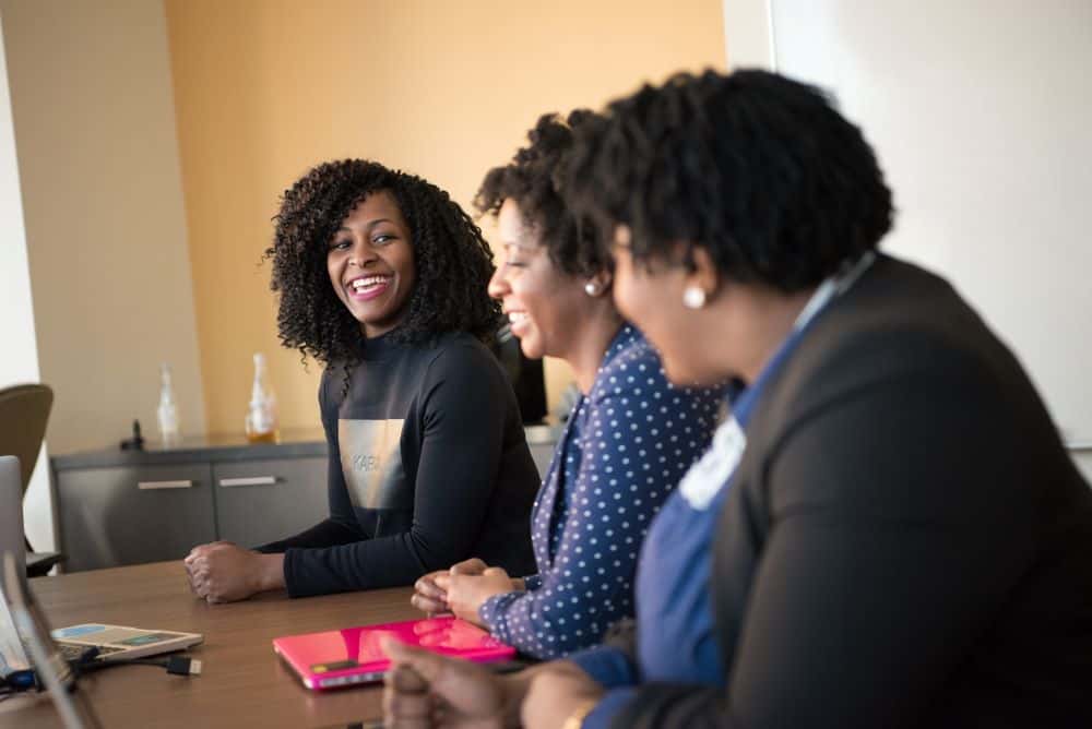 Professional women talking and laughing in a conference room