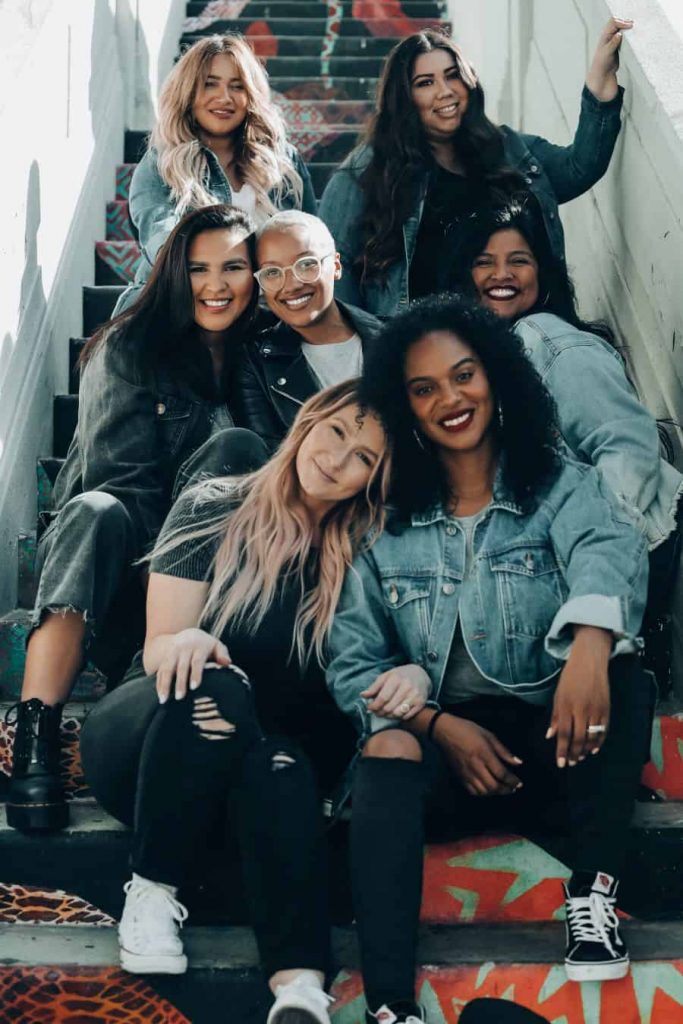 A group of 7 women posing on outdoor stairs