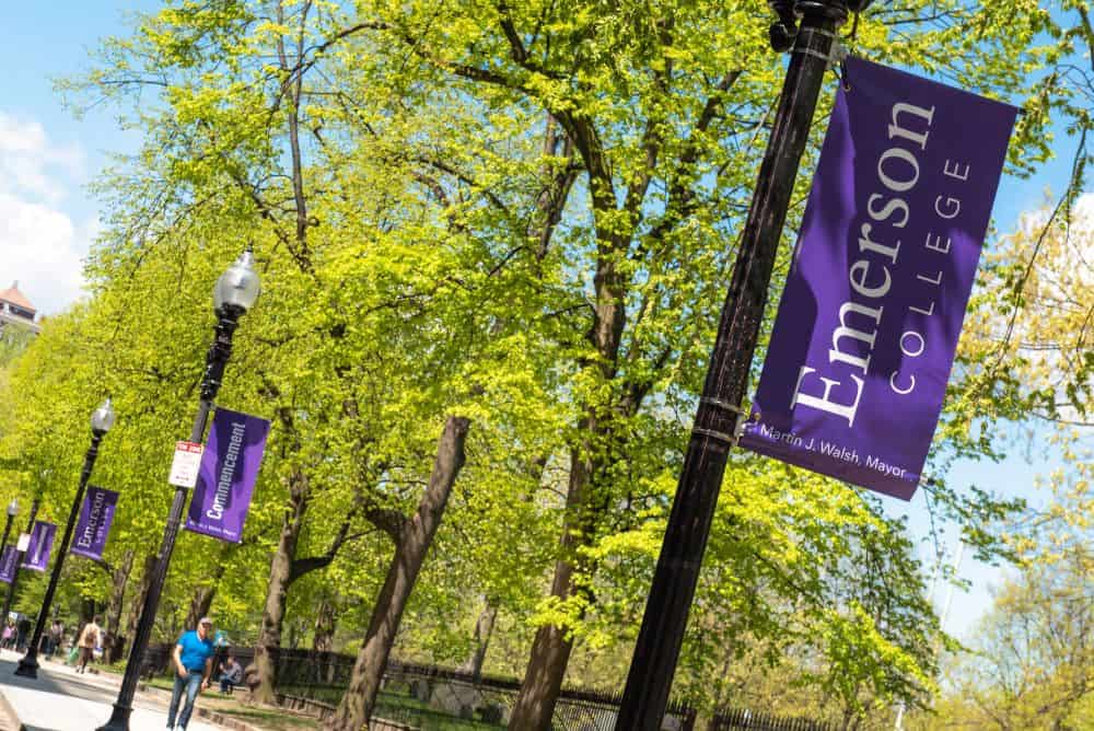 Emerson College banners  in front of bright green trees in spring