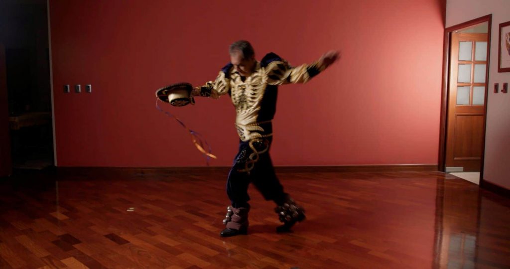 Isabel's father performing a Capores dance in traditional garb