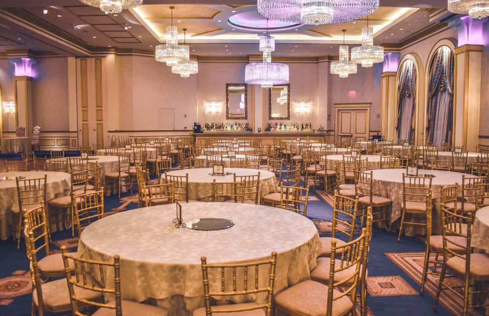 An event hall with tables and chairs, curated by an Events Coordinator