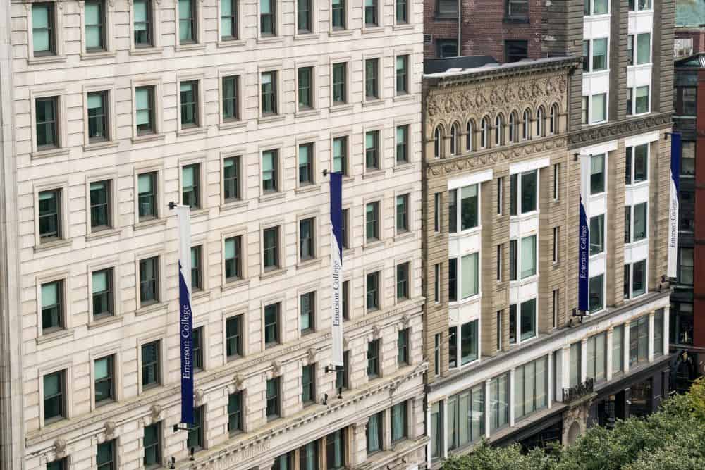 An aerial view of an Emerson campus building with banners reading "Emerson College"