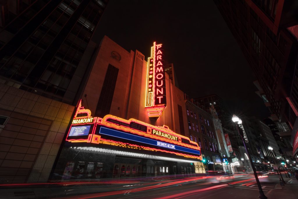 The bright exterior of Emerson's Paramount Theater, lighted at night