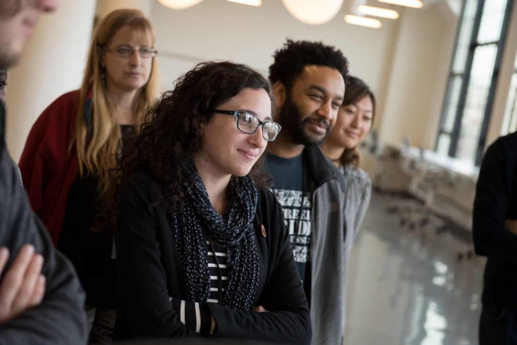 Five prospective students standing in an Emerson building, smiling