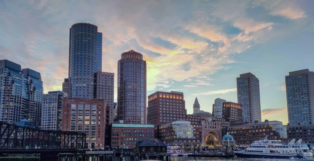 The Boston skyline as seen from the harbor at dusk