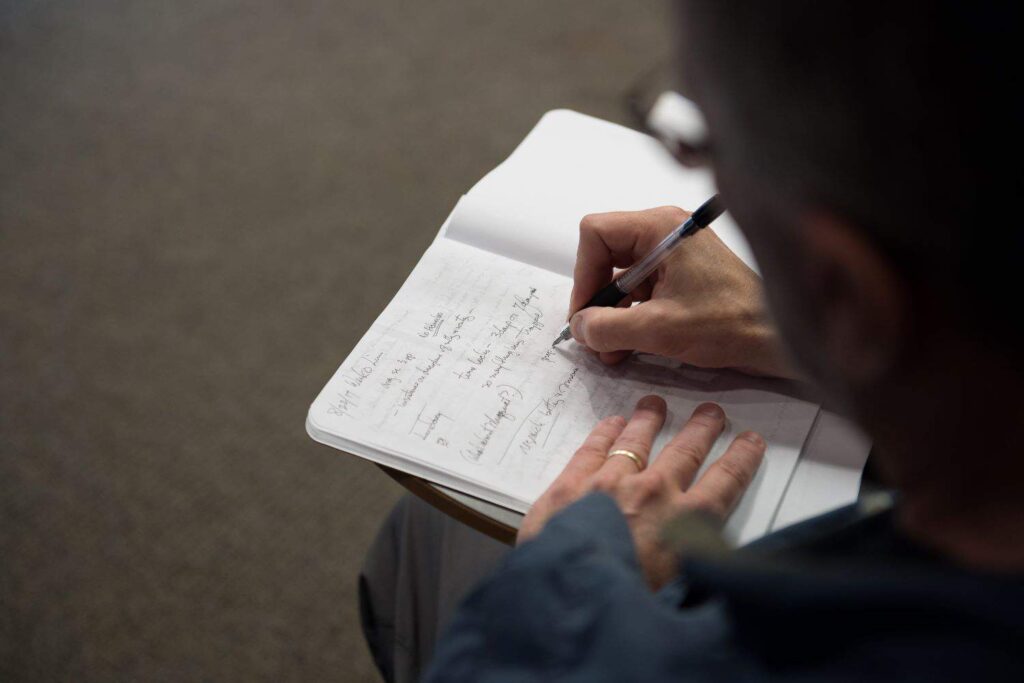A graduate applicant brainstorms in a notebook