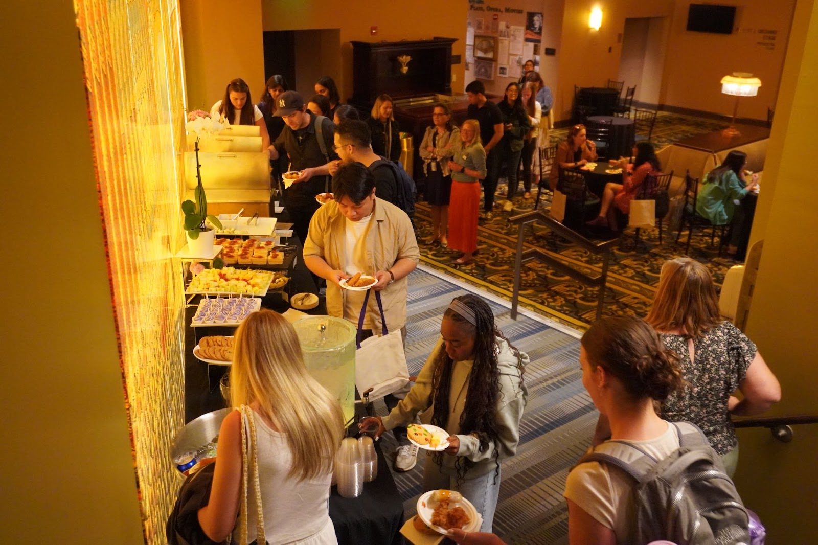 Students line up outside the theater during orientation to grab catered food by Emerson Dining.