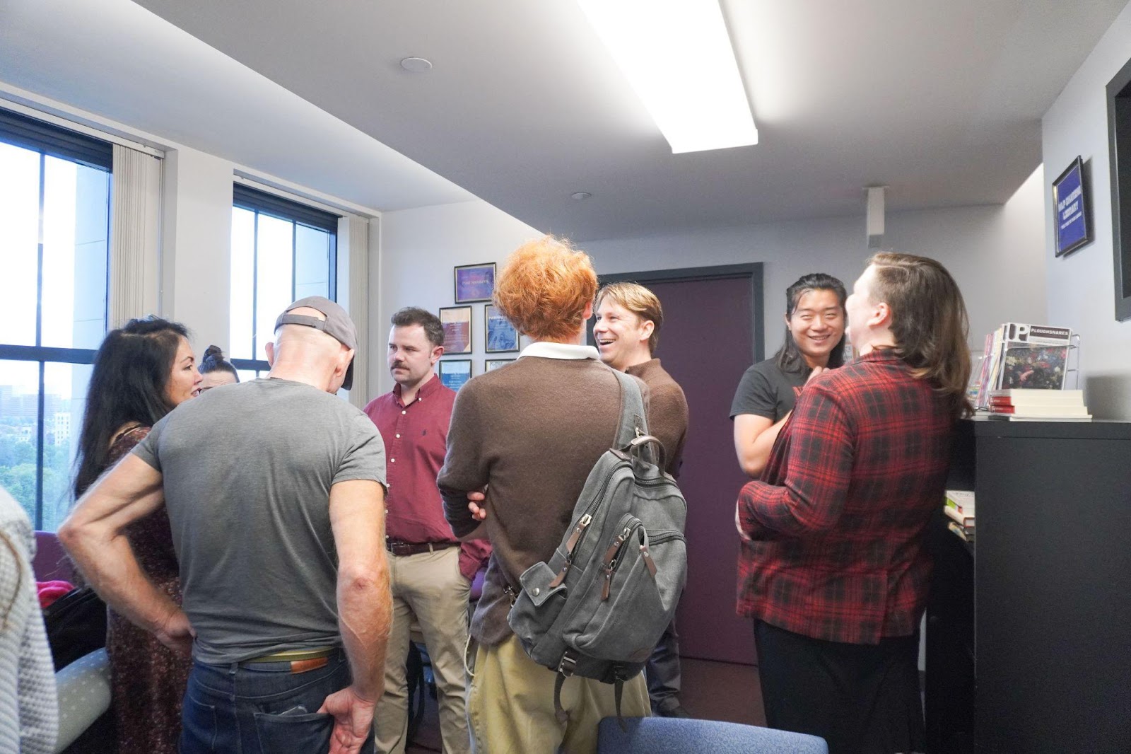 Students and faculty engage in conversation on the tenth floor of the Ansin building.