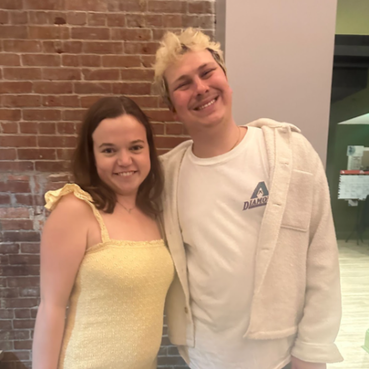 Two students pose at event.