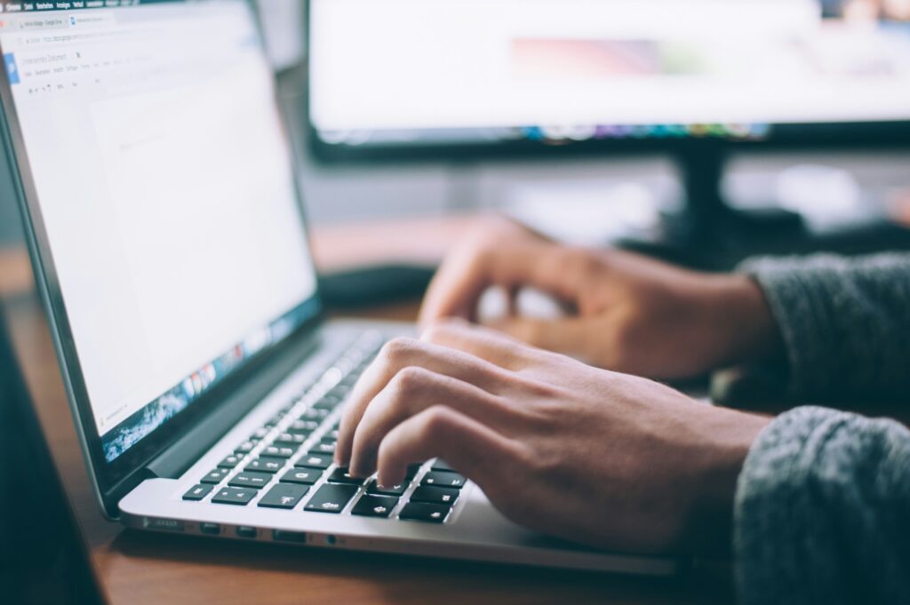 Person typing on computer keyboard.