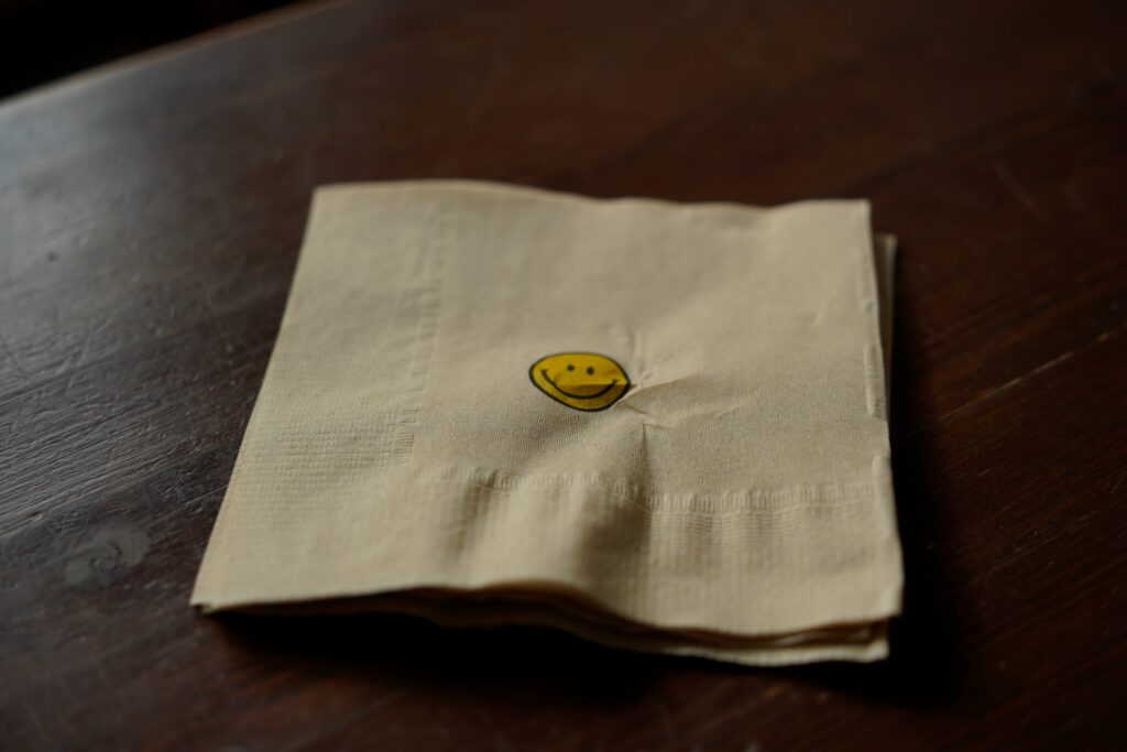 Napkin with smiley face on it.