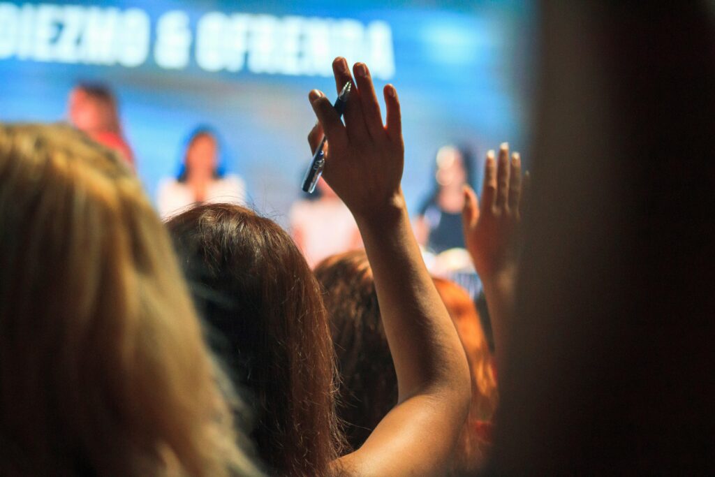 Hands raised at speech event.