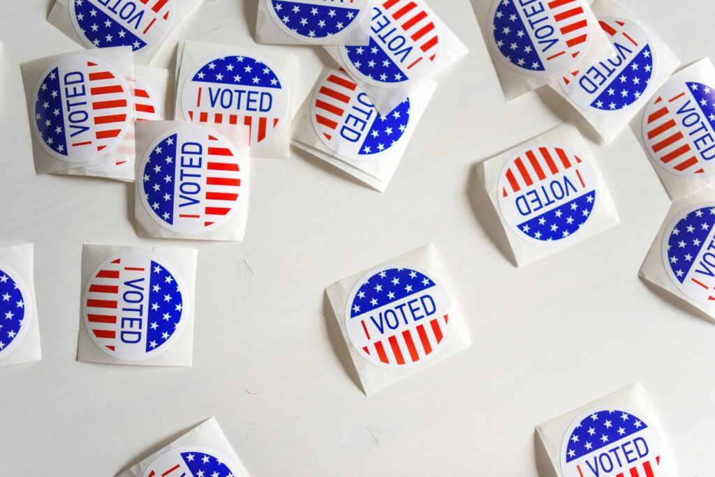 "I voted" stickers on a white table.