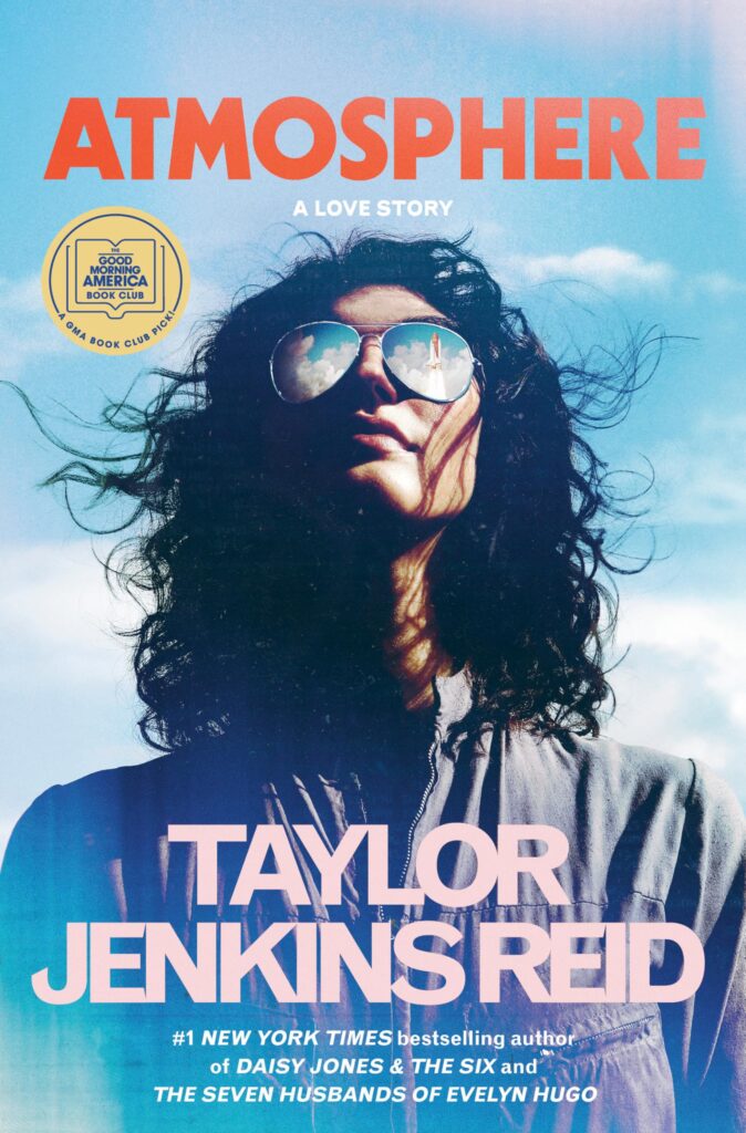 The book cover features a woman wearing aviator sunglasses as she looks up at the sky, a rocketship reflected in her glasses. She has curly black hair blowing in the wind.