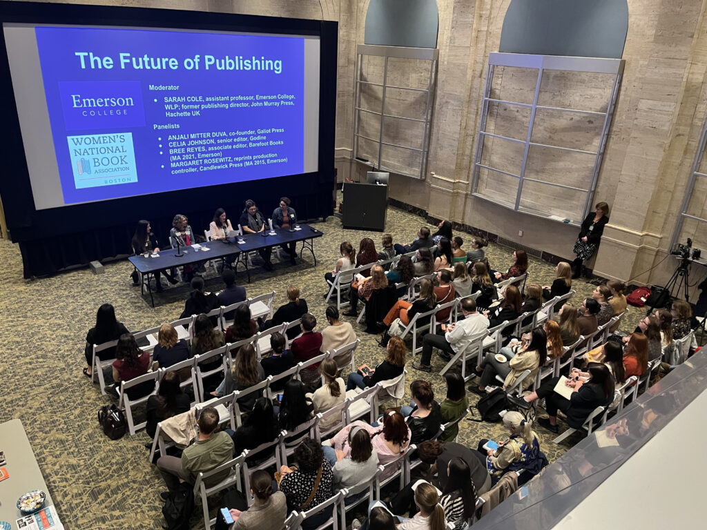 Shows the Bill Bordy Theater filled with attendees looking at the publishing panel, who sit in front of a projection screen that reads "The Future of Publishing."