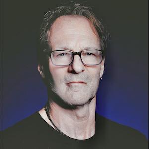 Doug Quintal's headshot. Middle-aged white man with glasses wearing a black shirt.