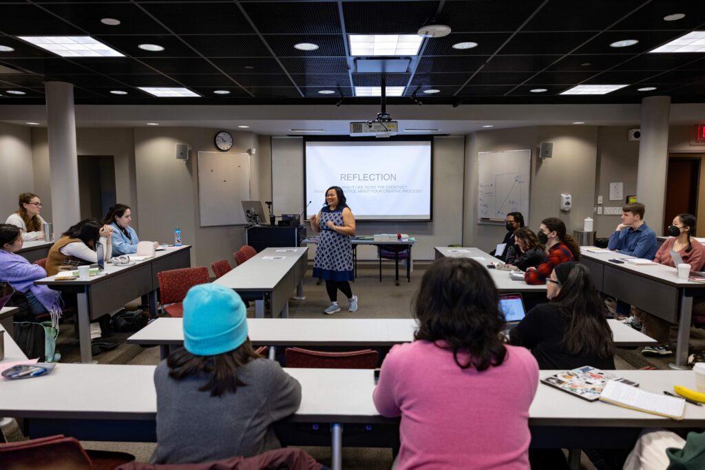 Emerson student presents in class to other students.