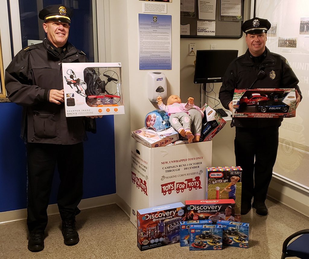 Deputy Chief Robert Cassagrande and Officer Ralph Fiore pose with Toys for Tots donations.