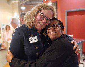 Richelle Devereaux-Murray and Nerissa Williams-Scott hugging and smiling