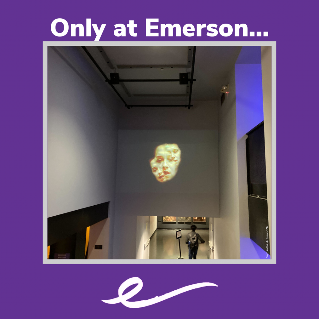 Art installation featuring a human face on the wall of the Tufte building, in a purple frame with the words "Only at Emerson"