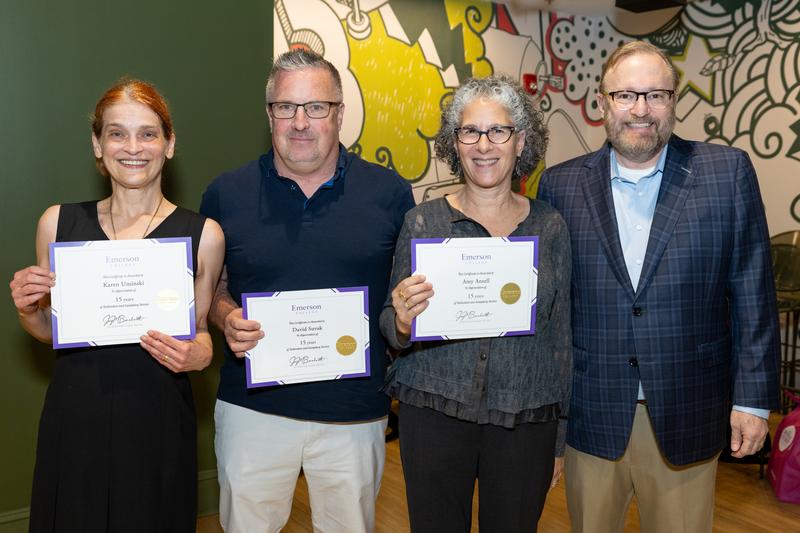 President Bernhardt poses with three staff members holding their service certificates